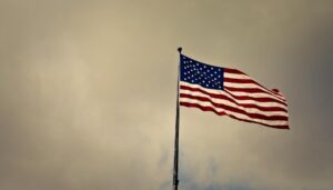 photo of cloudy skies over american flag