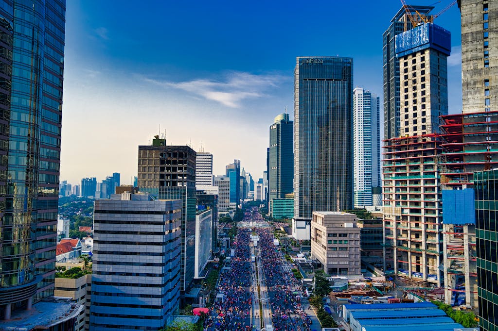 Stunning aerial view of Jakarta's modern skyline with bustling streets below. BPO Services